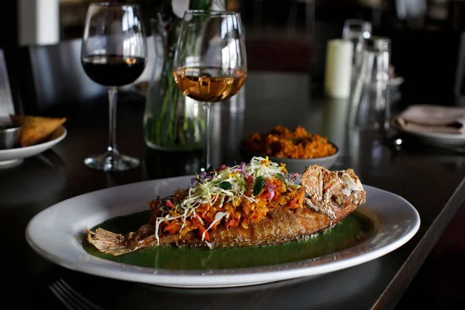 Catch of the Day plated with vegetables and fresh garnish