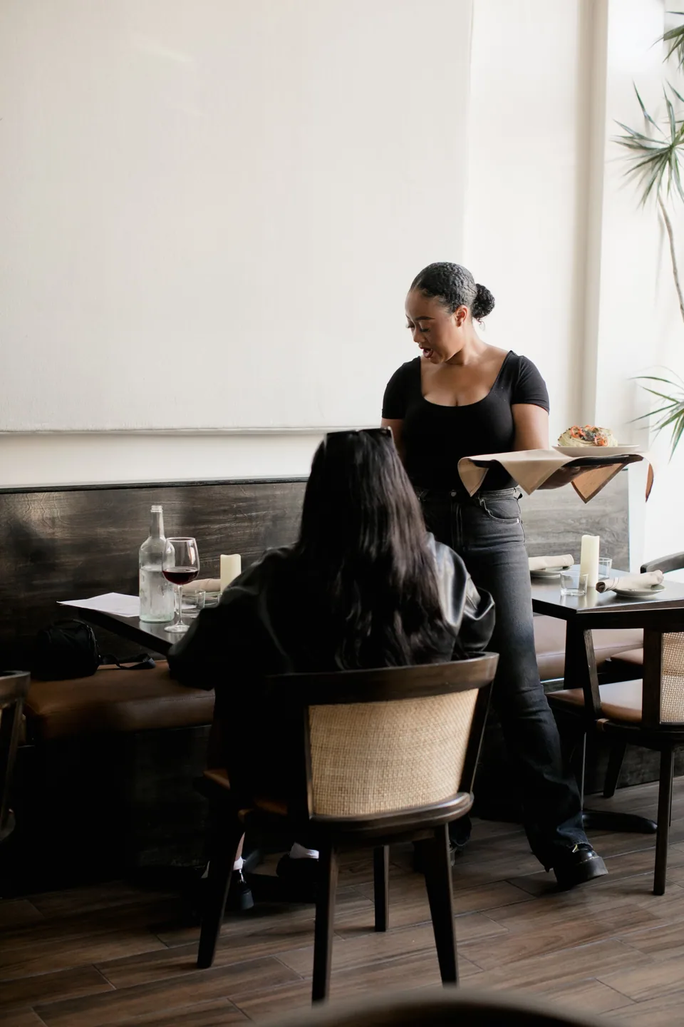 A team member serving guests in the dining room