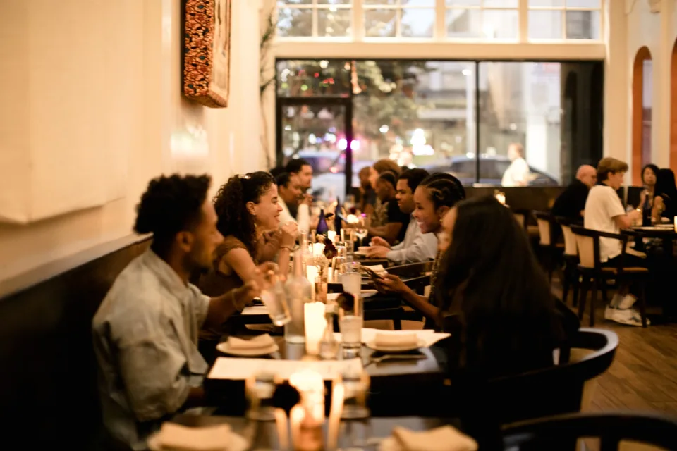 Guests sharing an evening meal in the dining room
