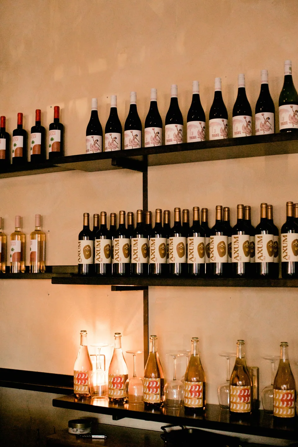African wine bottles on warmly lit shelves