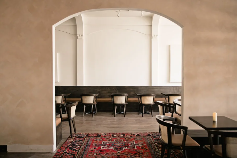 A plaster archway framing the restaurant dining room