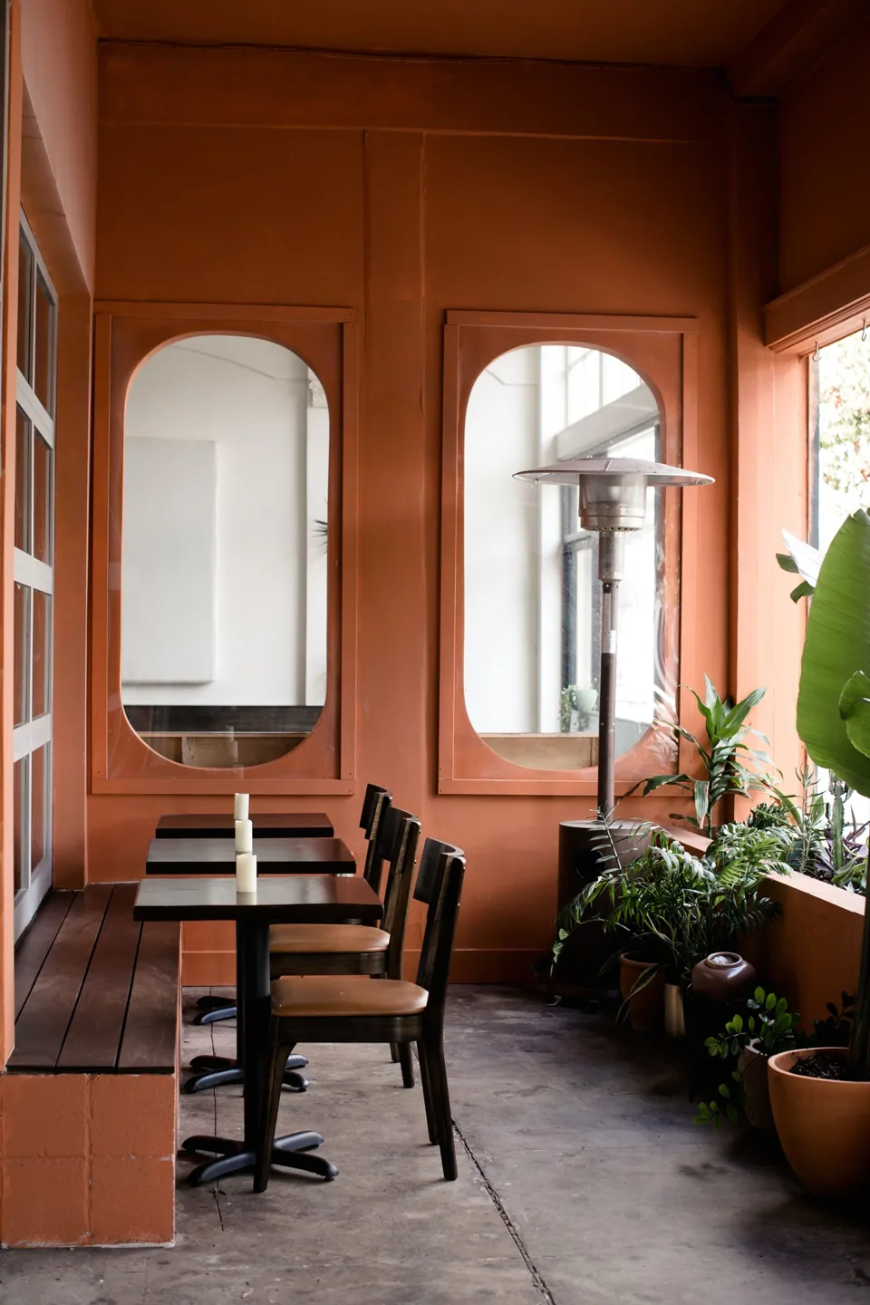 Terracotta walls, archways and dining tables at the restaurant